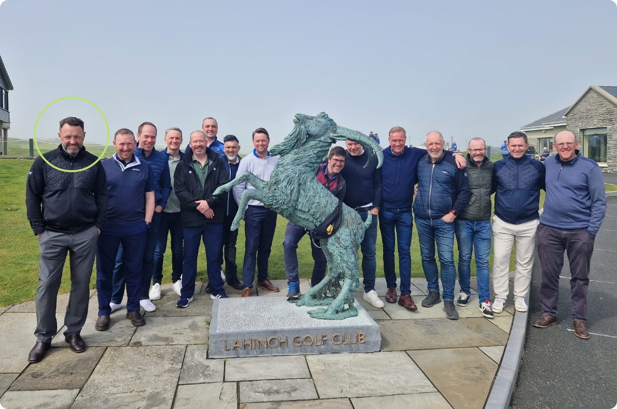 group of men beside a goat statue at lahinch golf club