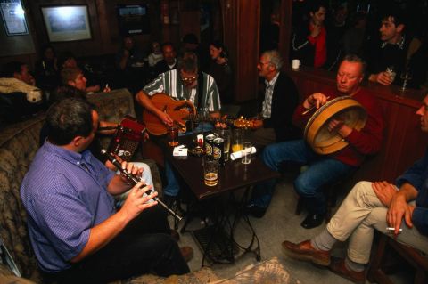 traditional irish musicians playing in a pub