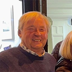 close up of smiling man as part of a group