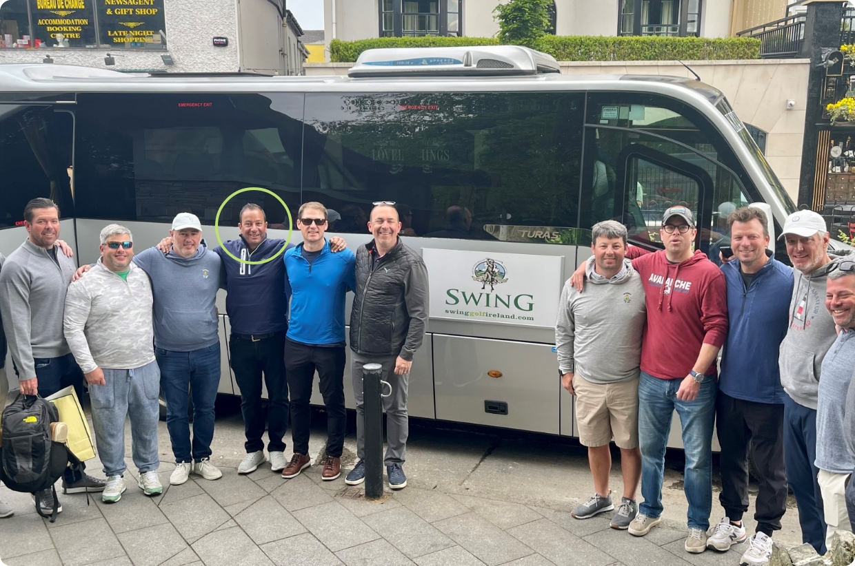 group of men in front of bus with swing golf logo