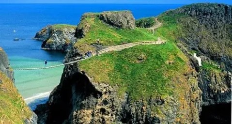 rope bridge stretching over cliffs with sea beneath