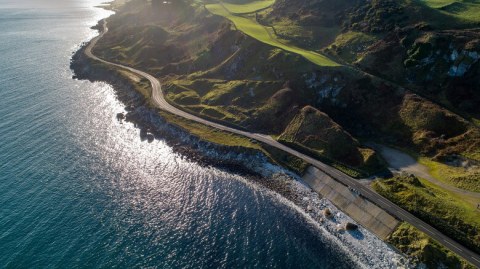 sunny aerial shot of coastal drive