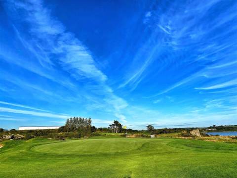 A golfing retreat near the sea in southwest Ireland with blue sky