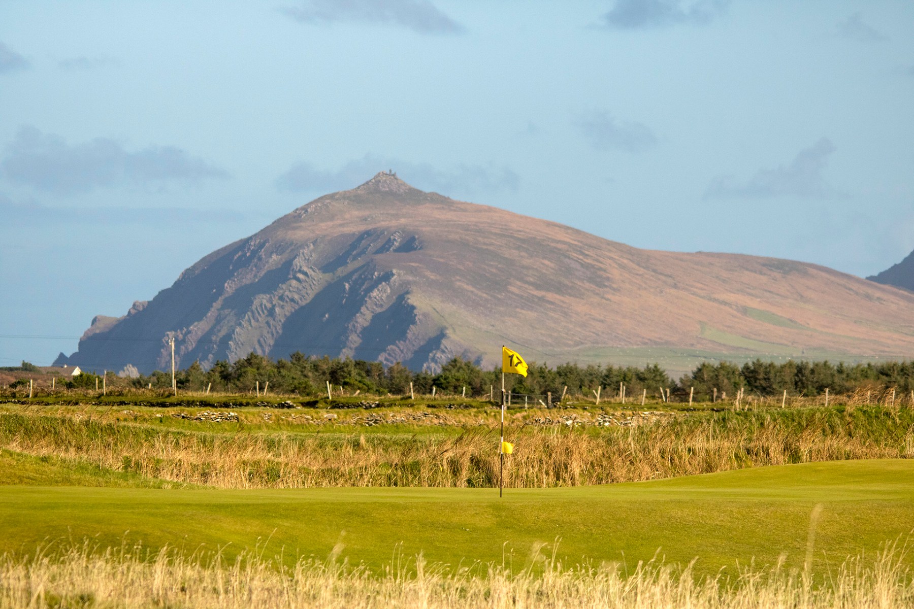 17th hole flag with mountain in the background