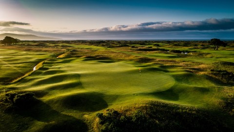 greens with dunes on championship golf course