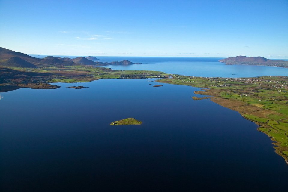 A large lake with mountains in the background lough currane