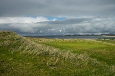 Golf course on Ireland's northwest coast under a cloudy sky