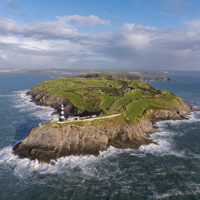 Aerial view of Old Head with a lighthouse and green landscape