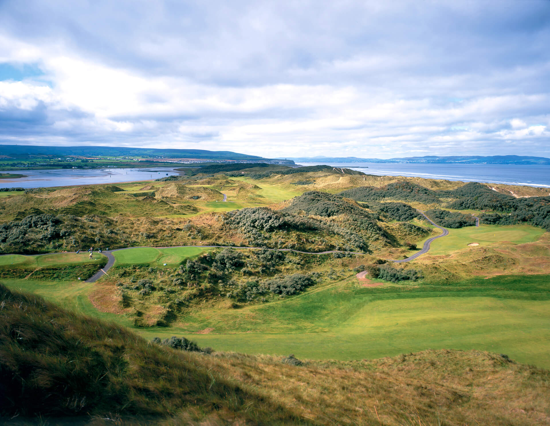 links style golf course with grey clouds and sea in background