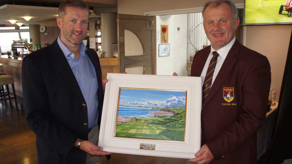 two men holding a painting