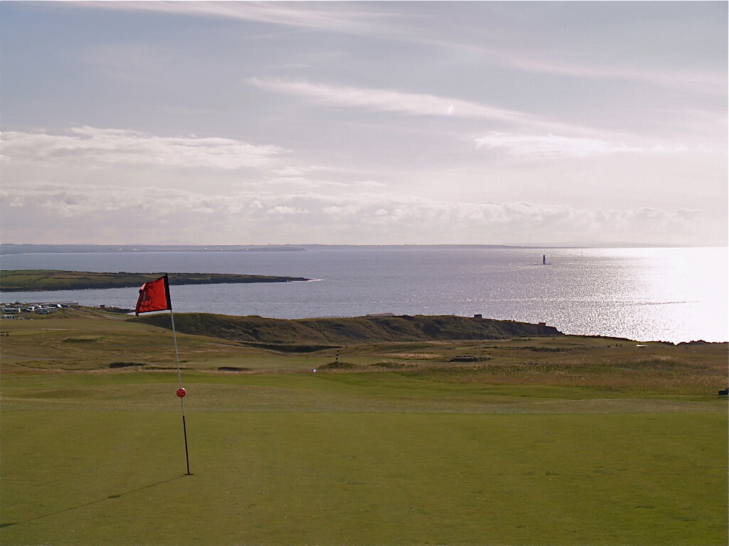 Irish golf course with a coastal view on a sunny day