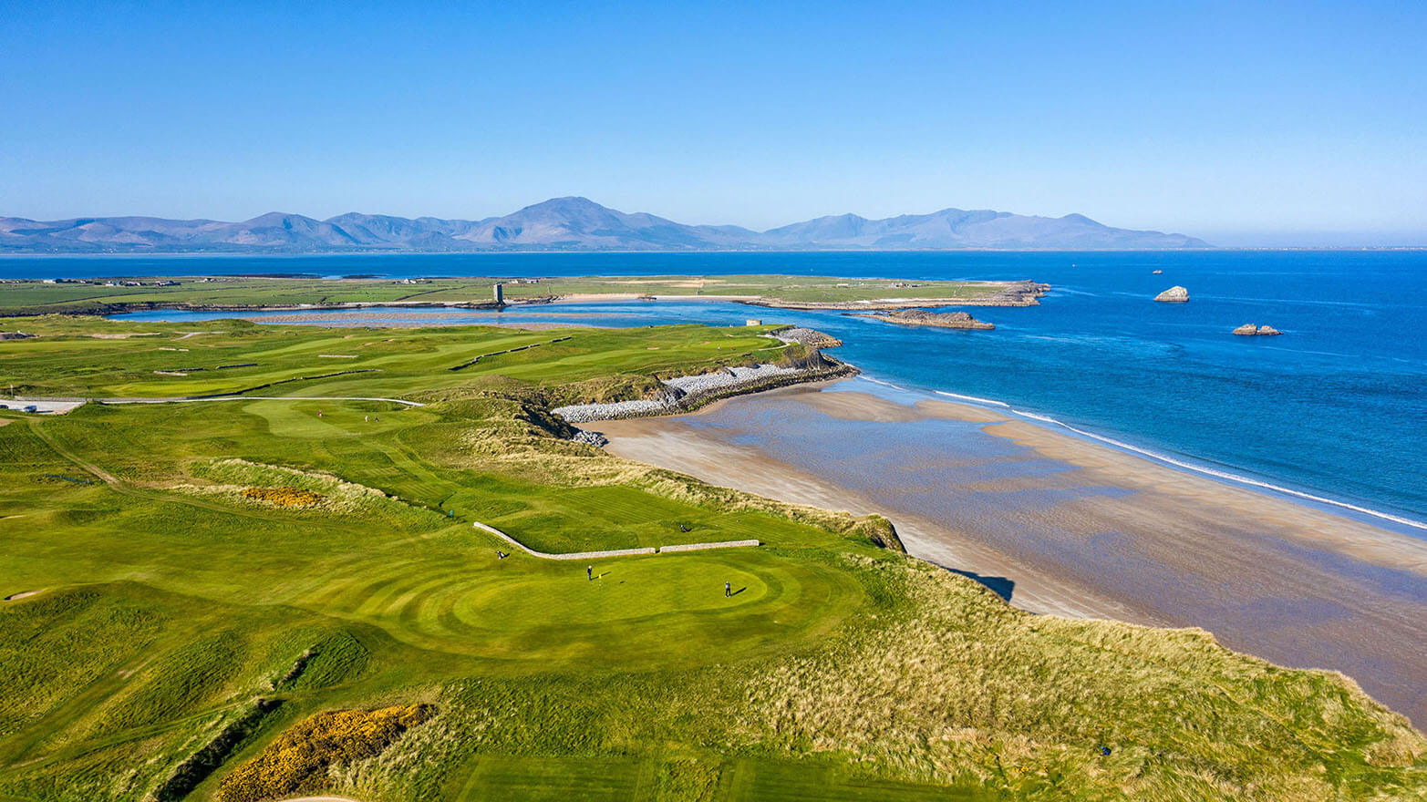 Coastal golf course in the southwest of Ireland with blue skies and sea