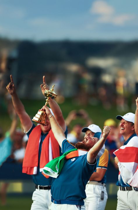 Celebration of golfers holding the Ryder Cup trophy with joy