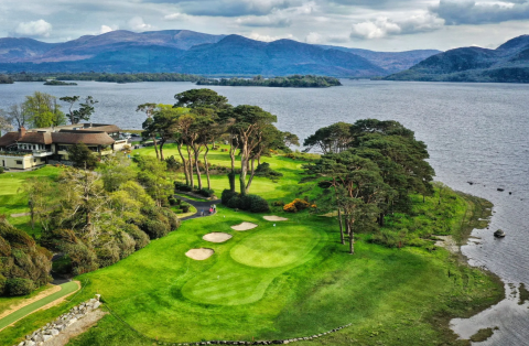 Aerial view of golf course and sand bunkers beside the coast
